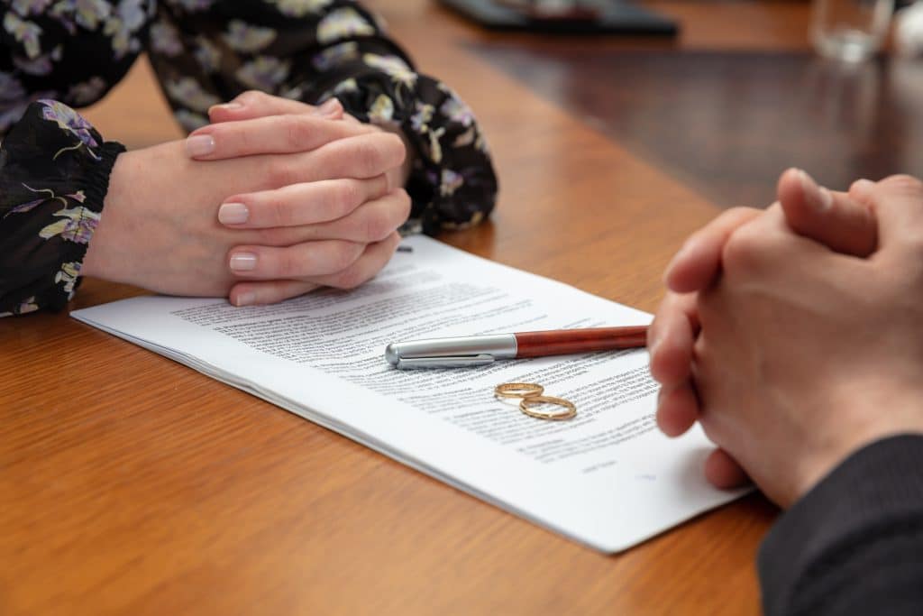 Divorce signature marriage dissolution document Wedding ring and agreement on lawyer office table