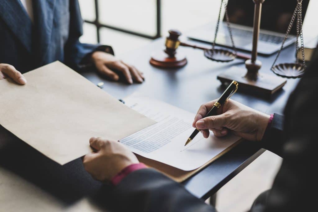 Lawyers negotiate agreements and sign contracts