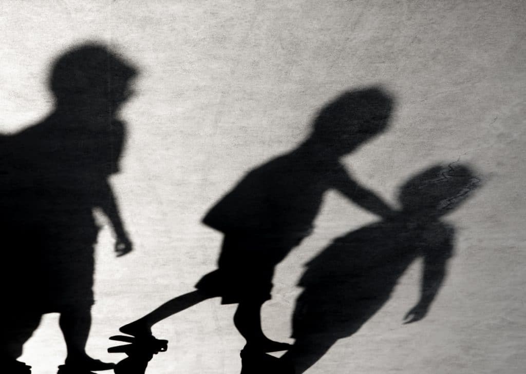 Blurry shadows of three boys