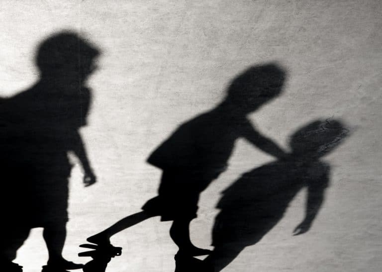 Blurry shadows of three boys